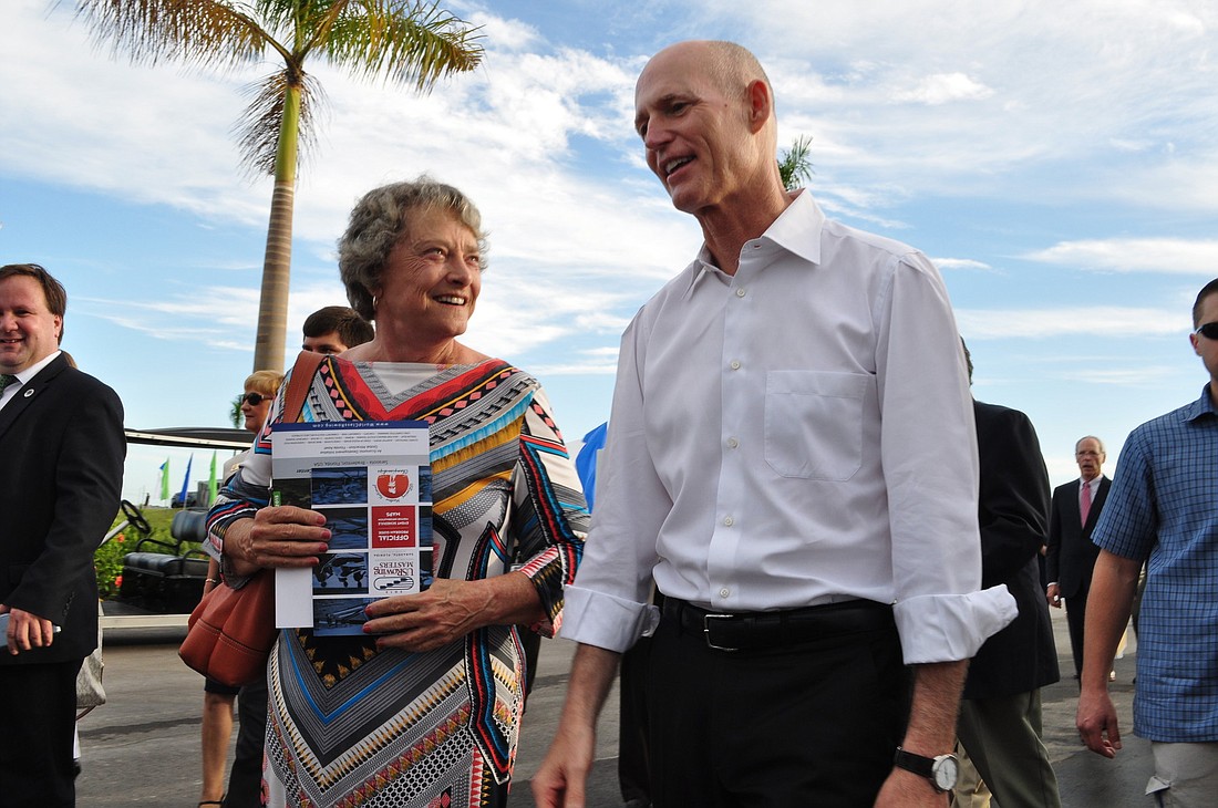 Sen. Nancy Detert walks with Gov. Rick Scott at Nathan Benderson Park, as he tours the facility and watches the 2013 USRowing Masters National Championships being held there.
