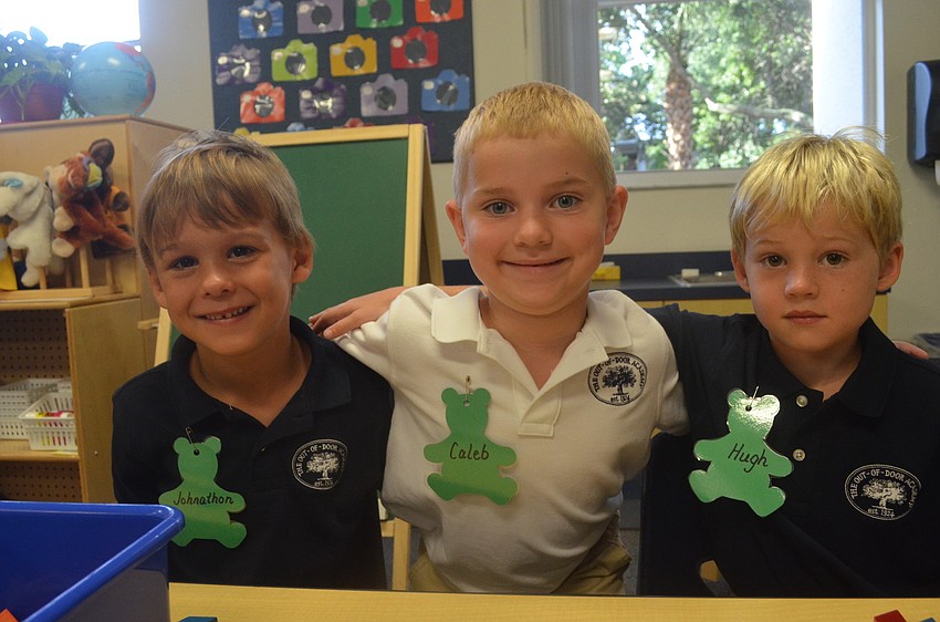 Johnathon P., Caleb C. and Hugh R. settle into their seats for the first day of kindergarten.
