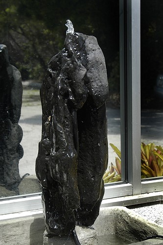 The statue of wisdom is a bubbling fountain waterfall made of basaltic rock.