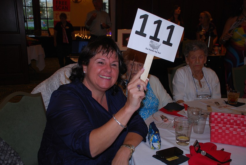 Christine Brudner takes part in the first auction of the night.