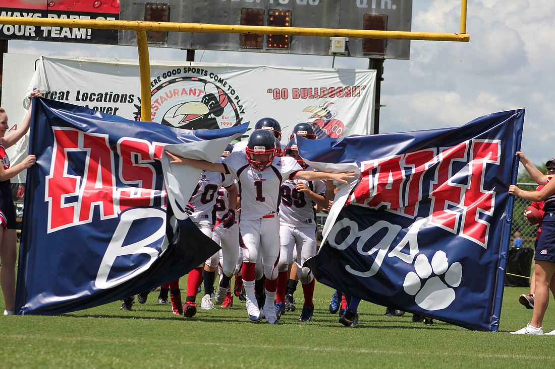 Mason Fischer leads the East Manatee Bulldogs out onto the field during the FYD Jamboree Aug. 24.