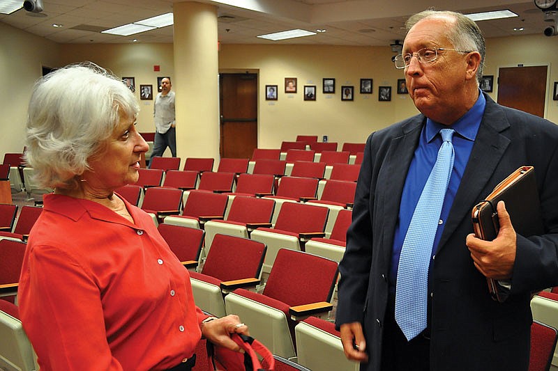 Loretto Sadkin, chairwoman of Peridia Golf and Country ClubÃ¢â‚¬â„¢s opposition group, and Manatee County Public Works Director Ron Schulhofer talk a recent commission meeting.