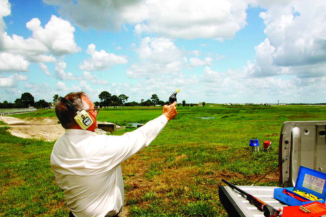 Roger Widrick, supervisor of airfield operations at SRQ, fires a pyrotechnic device used to scare birds away from runways and taxiways.