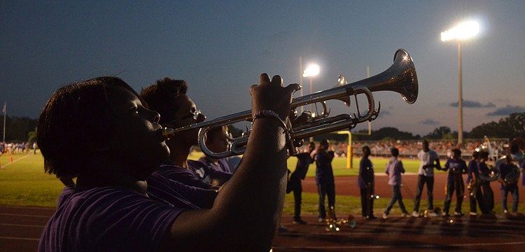 Senior and band captain of Booker High School Chelse Russ warms up before the half time show.