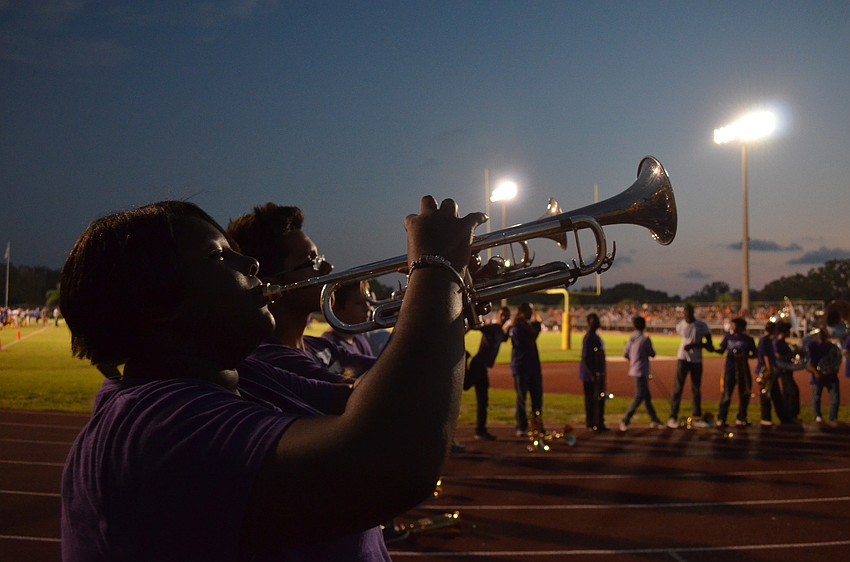 Senior and band captain of Booker High School Chelse Russ warms up before the half time show.