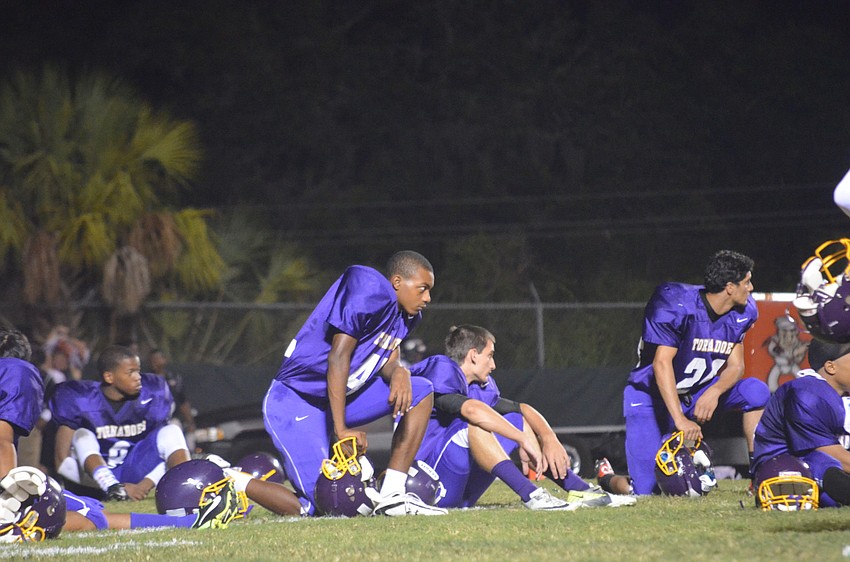 Booker High School football player Sam Barber waits for halftime to end so he can get back out on the field.