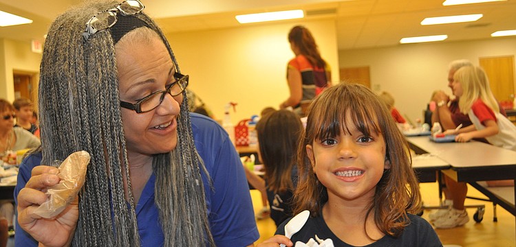 Kitty Brooks surprises her granddaughter, Jade Voorhees, with a cookie for dessert