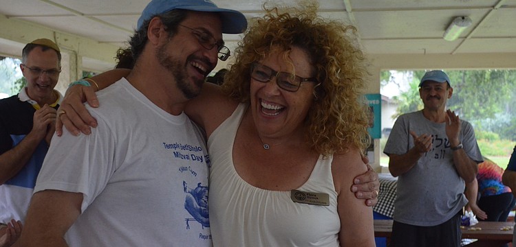 Hazzan Jeffrey Weber and Flora Oynick dance and laugh during the celebration.