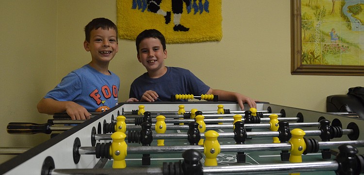David Bayer and Garet Pearson play foosball.