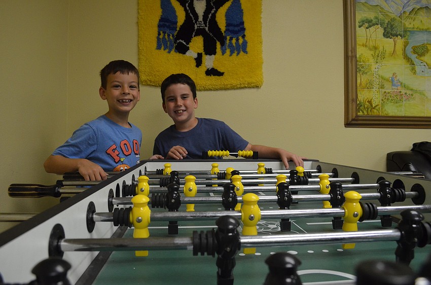 David Bayer and Garet Pearson play foosball.