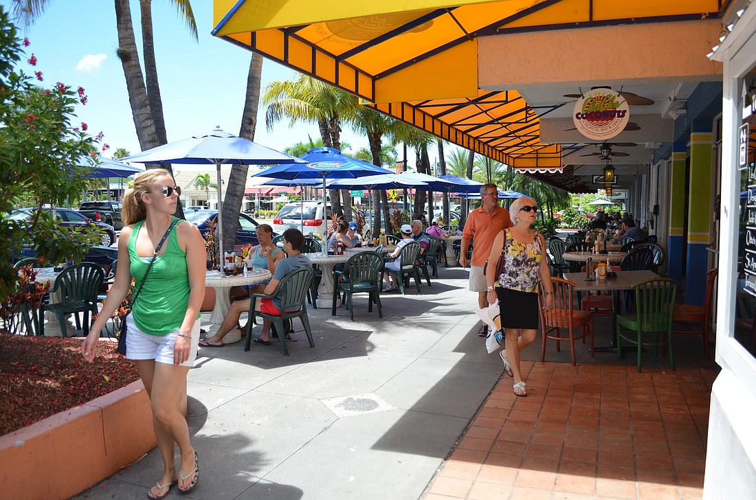 Even on a Thursday afternoon in the slow month of September, shoppers and diners filled up St. Armands Circle.