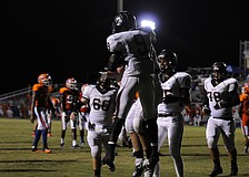 Braden River running back Titus Humphrey is congratulated by his teammates following his 13-yard touchdown run.