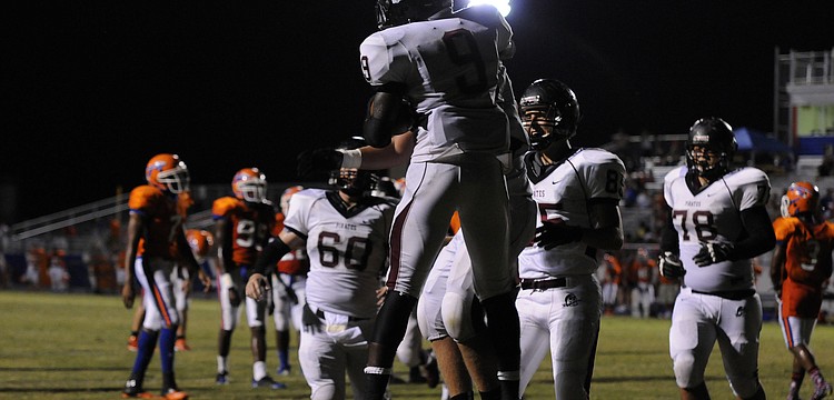Braden River running back Titus Humphrey is congratulated by his teammates following his 13-yard touchdown run.