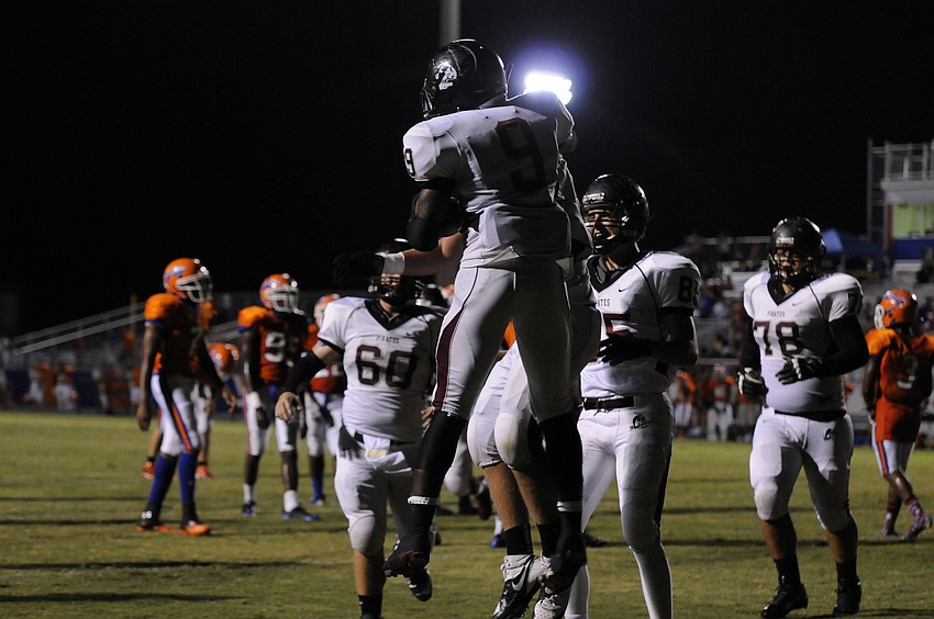 Braden River running back Titus Humphrey is congratulated by his teammates following his 13-yard touchdown run.