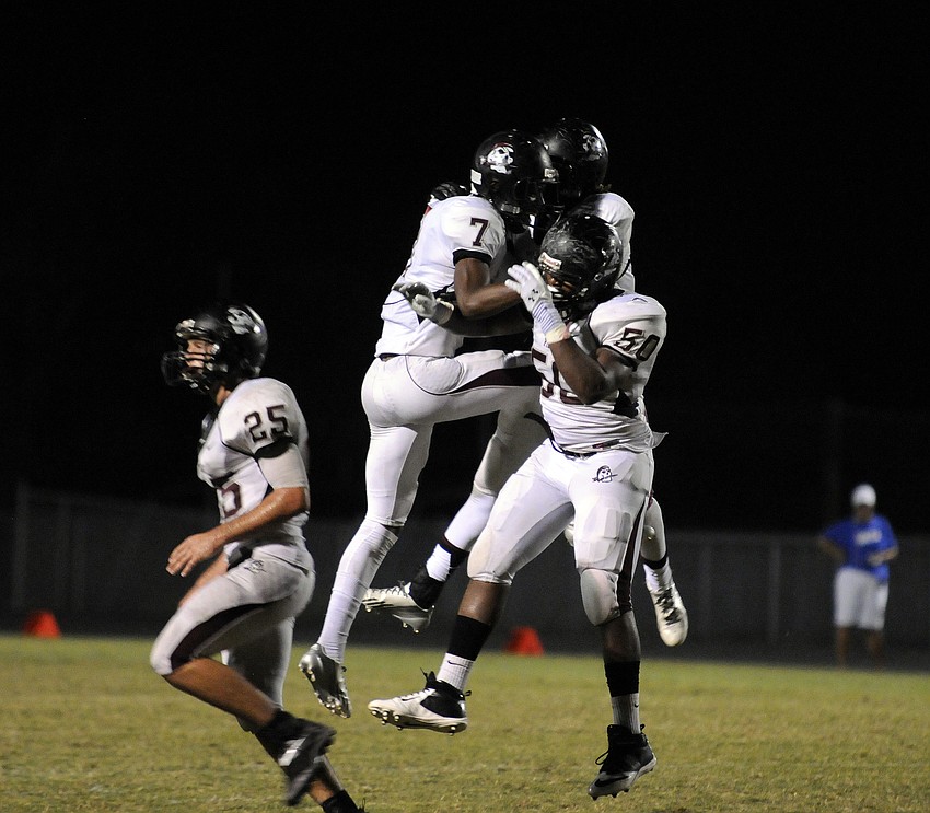 Justin Ross, Kelvin Albritton and Curtis Govan celebrate following the Pirates third fumble recovery.
