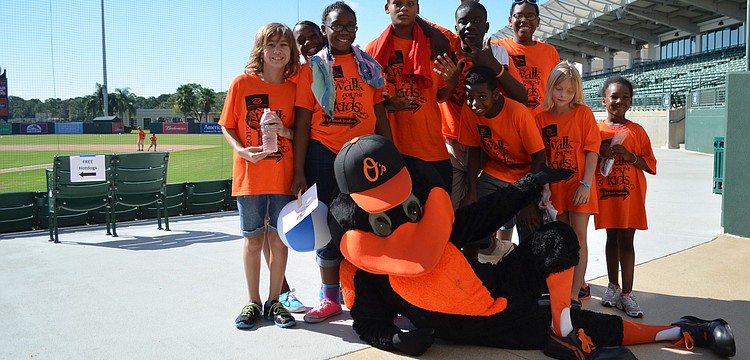 Oriole the Bird poses with some of the kids at the 2013 Walk for the Kids event.