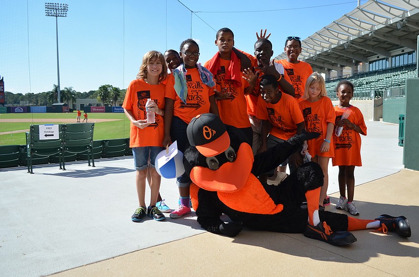 Oriole the Bird poses with some of the kids at the 2013 Walk for the Kids event.