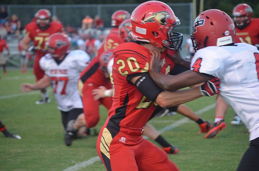 Senior Eric Kreger blocks an Avon Park player during the game Friday night.
