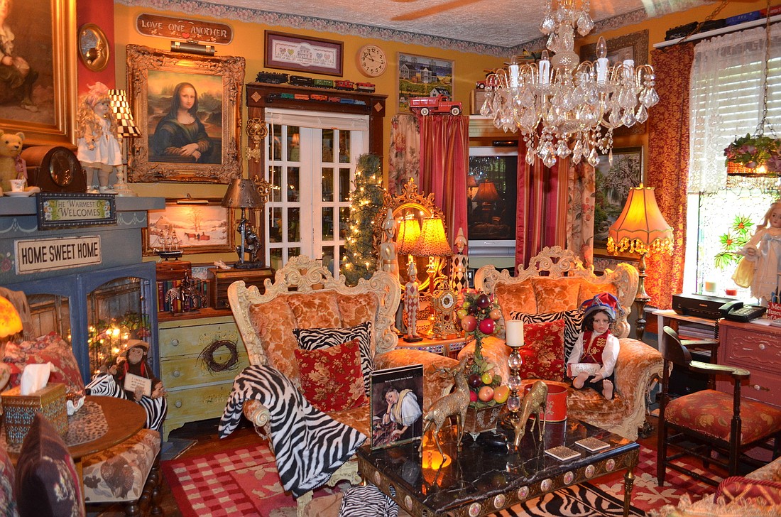 Years of collecting fill the Zurich-Wus living room with sparkle and splendor. The Greek doll in the rococo chair is by Tampa artist Fayzah Spanos and the chandelier is a Craigslist find.
