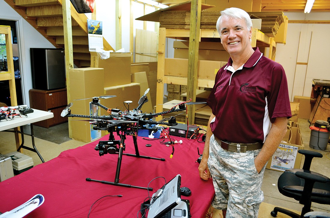 Gene Payson shows off the S-800 hexacopter drone Ã¢â‚¬â€ one of the small-scale unmanned aerial vehicles used to train drone pilots.