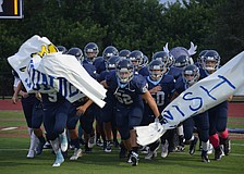 Maxime Provost and his teammates rush out for Friday night football.