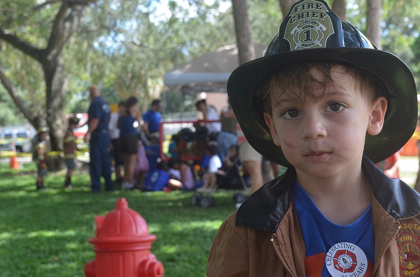 Luca Tucci, 3, goes through the Junior Fireman Combat Challenge.