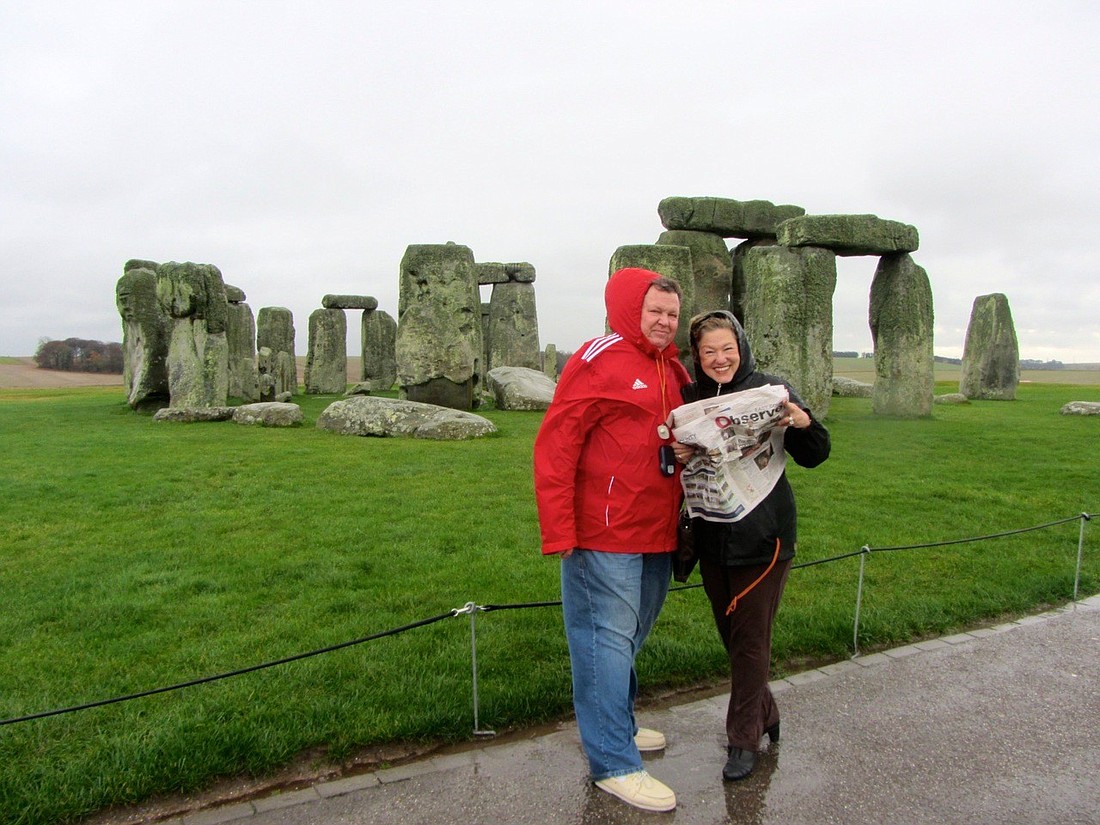 East County residents catch up on their Observer news while sightseeing at Stonehenge in the English countryside.