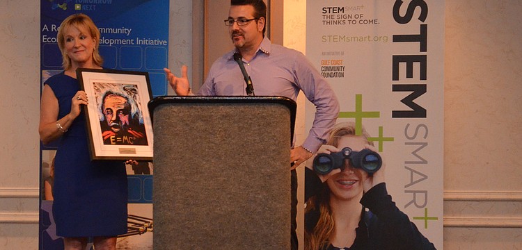 Teri Hansen presents Jeff Hazelton with the STEM Smart Innovation Award.