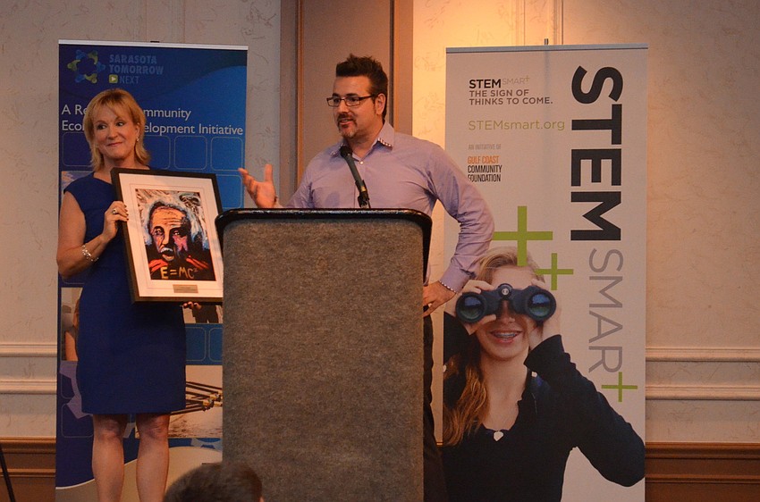 Teri Hansen presents Jeff Hazelton with the STEM Smart Innovation Award.