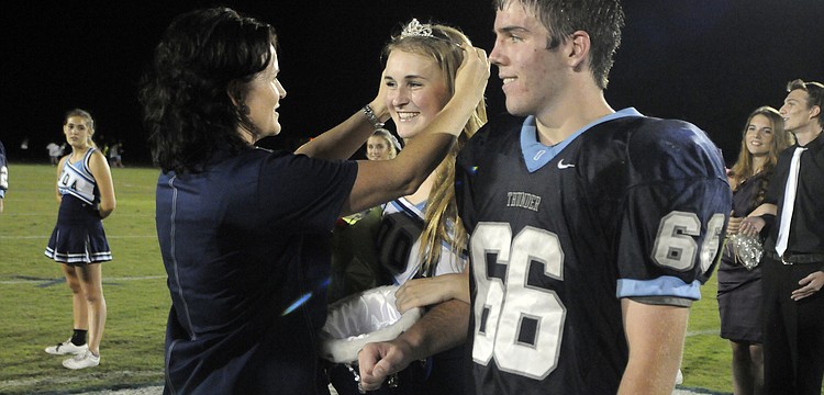 ODA Head of Upper School Noel Dougherty crowns Homecoming Queen Emma Holland and Homecoming King Quinton Fitzgerald during halftime.