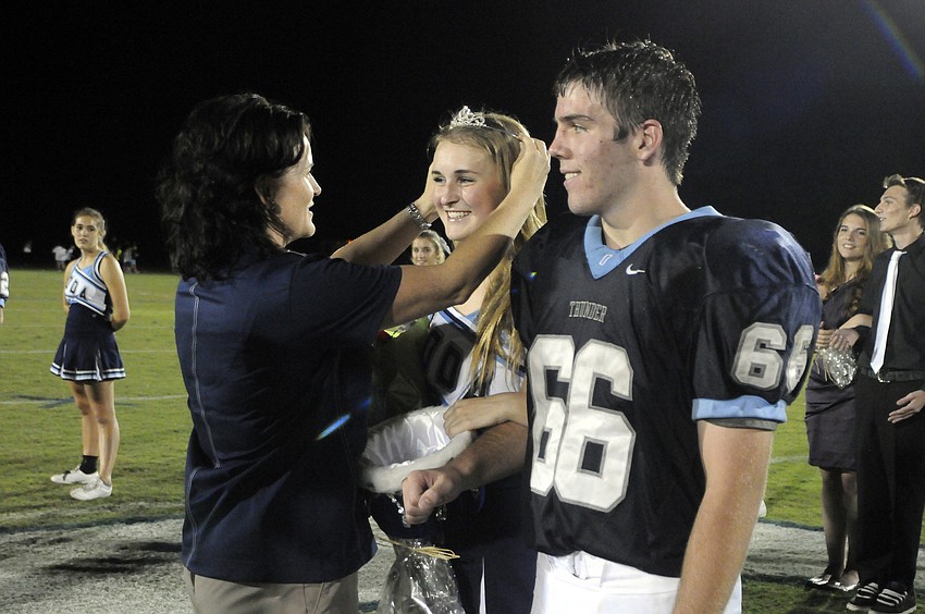 ODA Head of Upper School Noel Dougherty crowns Homecoming Queen Emma Holland and Homecoming King Quinton Fitzgerald during halftime.