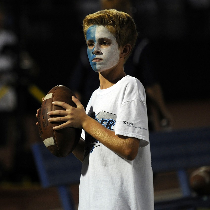 ODA seventh-grader Cameron Weber throws a football back and forth on the sidelines.