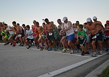 Runners race off the start line at Phillippi Shores 7K.