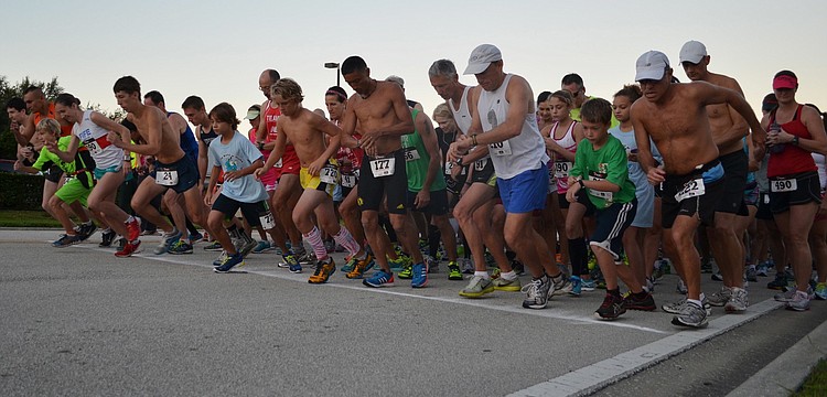 Runners race off the start line at Phillippi Shores 7K.