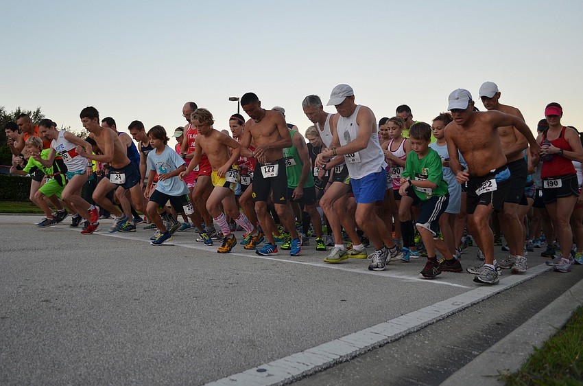 Runners race off the start line at Phillippi Shores 7K.