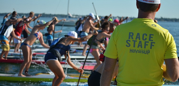 The 6.5 mile paddle board race begins.