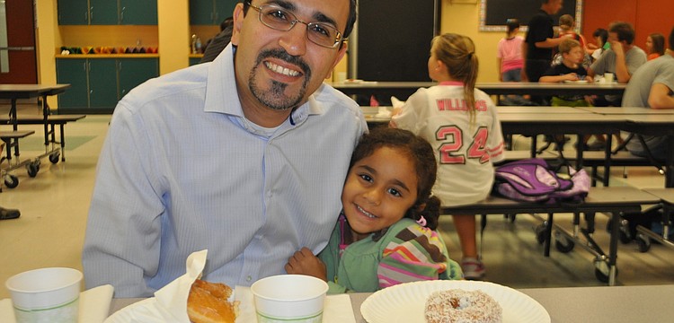 Joseph and daughter Lilly Younan,4, have a glazed and coconut donut
