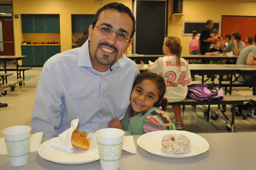 Joseph and daughter Lilly Younan,4, have a glazed and coconut donut