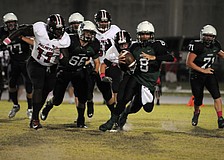 Lakewood Ranch High quarterback Chad Rex scrambles for yardage in the first half of the Mustangs district game versus Palmetto Oct. 18.