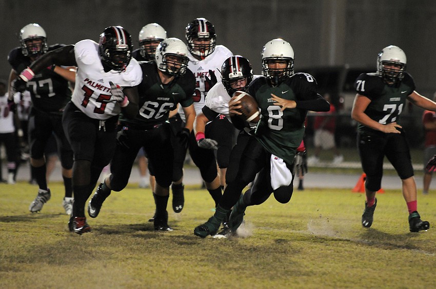 Lakewood Ranch High quarterback Chad Rex scrambles for yardage in the first half of the Mustangs district game versus Palmetto Oct. 18.