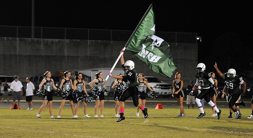 Lakewood Ranch defensive back James Jeffcoat leads the Mustangs out onto the field for their district game versus Palmetto Oct. 18.