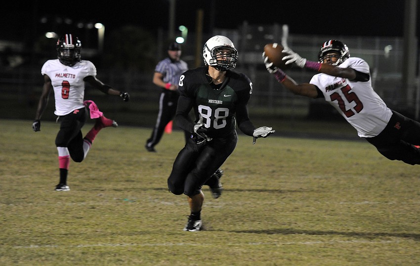A Palmetto defender intercepts a pass intended for Lakewood Ranch tight end Wyatt McLeod.