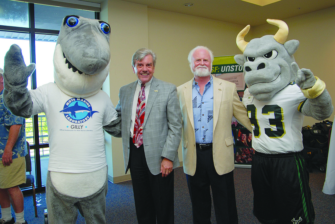 Mote mascot Gilly the Shark, Dr. Arthur Guilford, regional chancellor of USFSM, Dr. Michael Crosby, president and CEO of Mote, and USFSM mascot Rocky D. Bull.