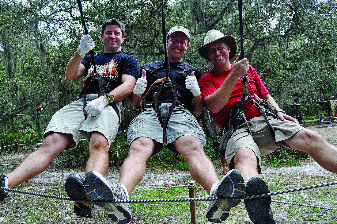 Matt Selman, Mark Leatt and Aaron Corr, part of a 10-person Tough Mudder team with the slogan Ã¢â‚¬Å“Kids with OI are tougher than us,Ã¢â‚¬Â climb trees at TreeUmph! to prepare.