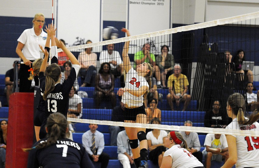 Cardinal Mooney outside hitter Keri McMahon serves the ball back over the net during the second set.