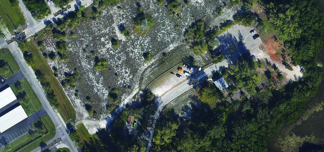 The aerial photo shows the parking lot of Ted Sperling Park on Lido Key and portions of the vacant site next to the parking lot. The park is a favorite for kayakers.