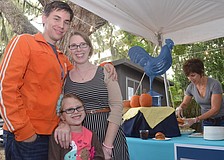 Melissa and Brian Precourt and their daughter Gwendolyn, 5, get ready to sample a Blue Rooster pulled pork slider.