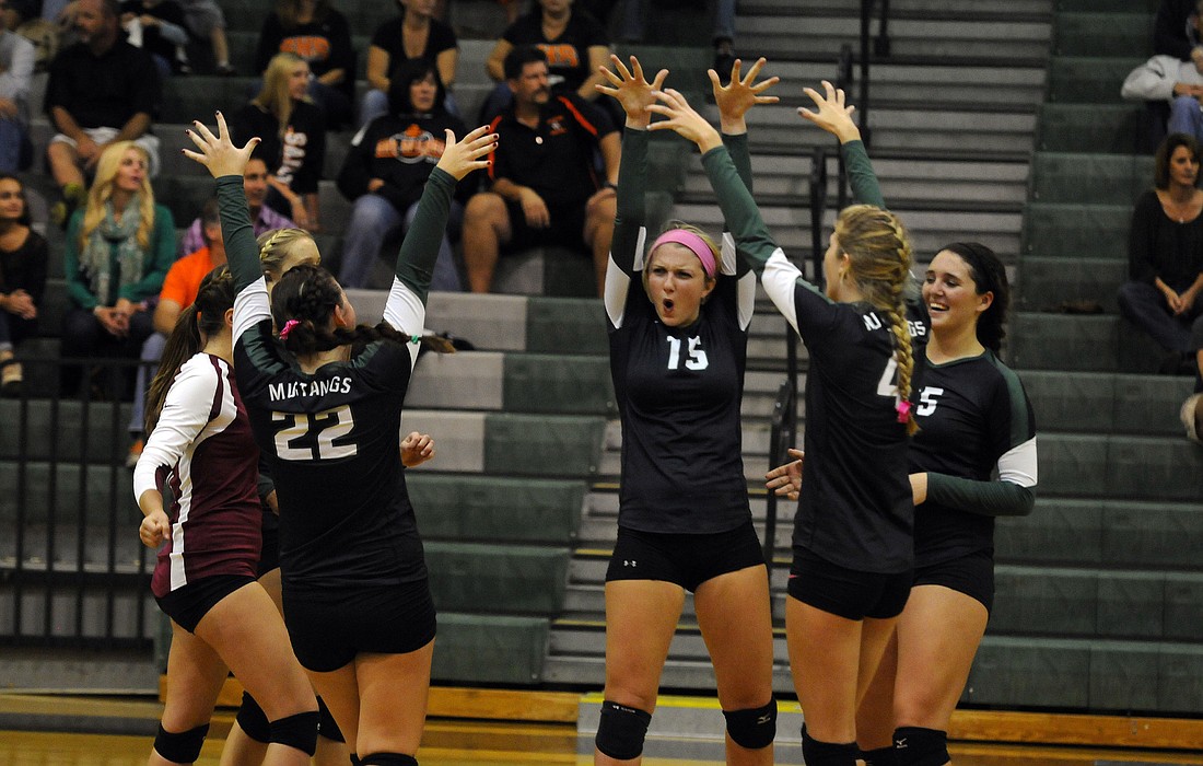 The Lakewood Ranch High volleyball team celebrates a point during its 3-1 victory over Sarasota in the Class 7A-District 10 championship Oct. 24.