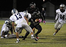 Braden River running back Titus Humphrey carries the ball up the middle for a positive gain.