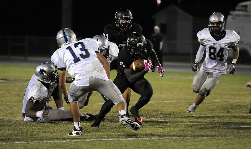 Braden River running back Titus Humphrey carries the ball up the middle for a positive gain.
